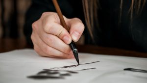 Calligrapher writing with brush